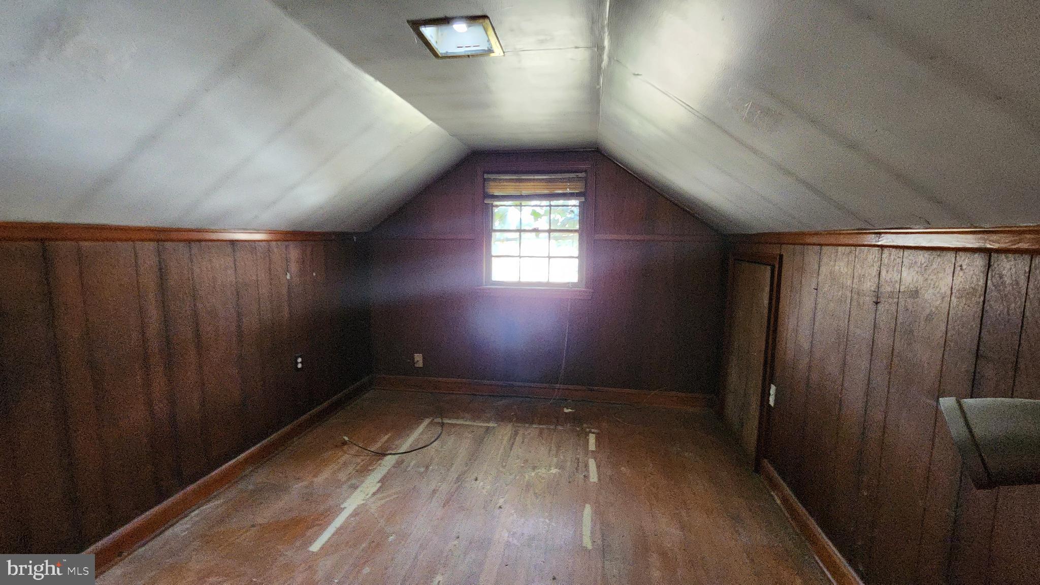 936 Olmstead Road Baltimore, MD 21208 - Photo 20 of 24 wooden floor in an empty room with a window