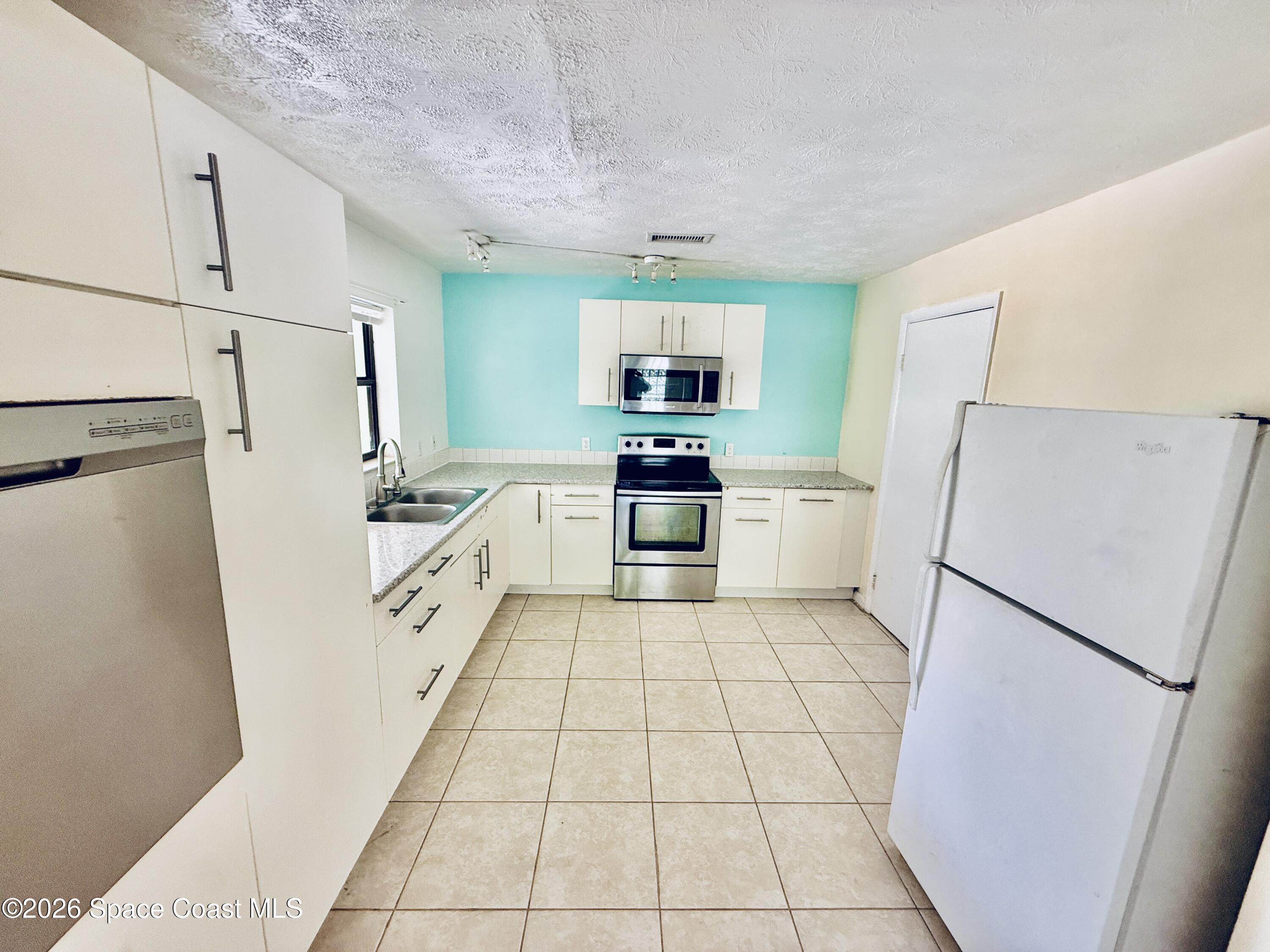 410 South Tropical Trail Merritt Island, FL 32952 - Photo 9 of 28 20260309_161345771_iOS
