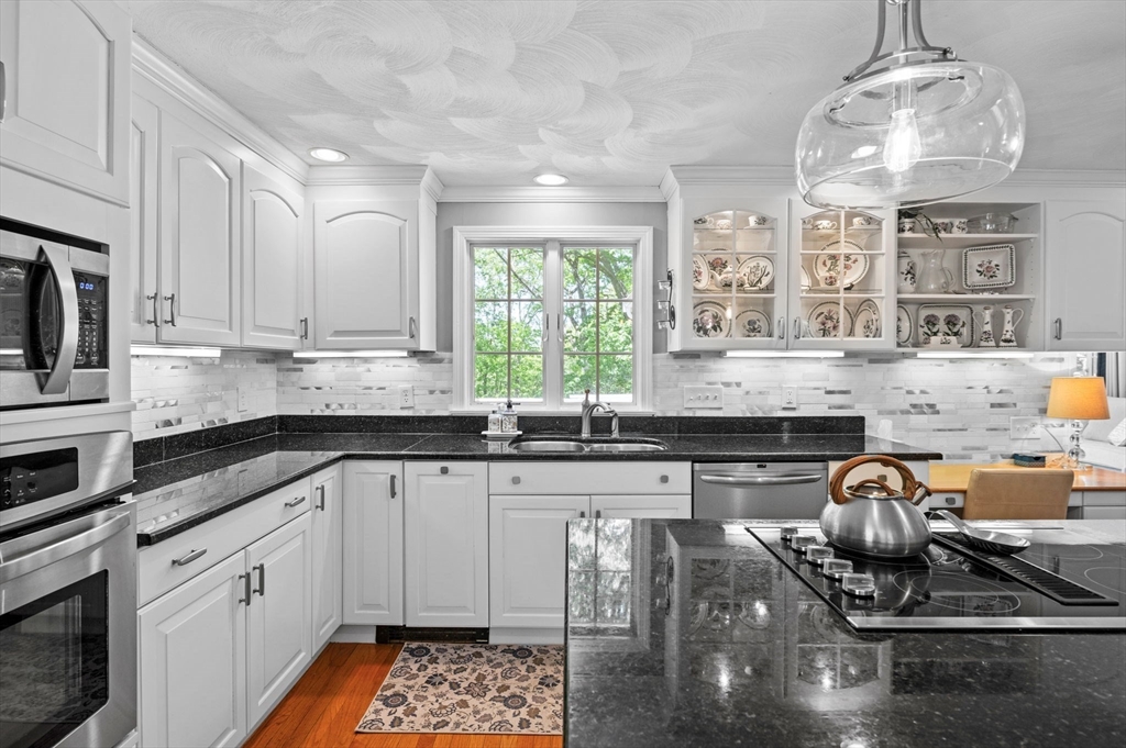 9 Sagamore Road Ipswich, MA 01938 - Photo 15 of 42 a kitchen with stainless steel appliances granite countertop a stove sink and cabinets