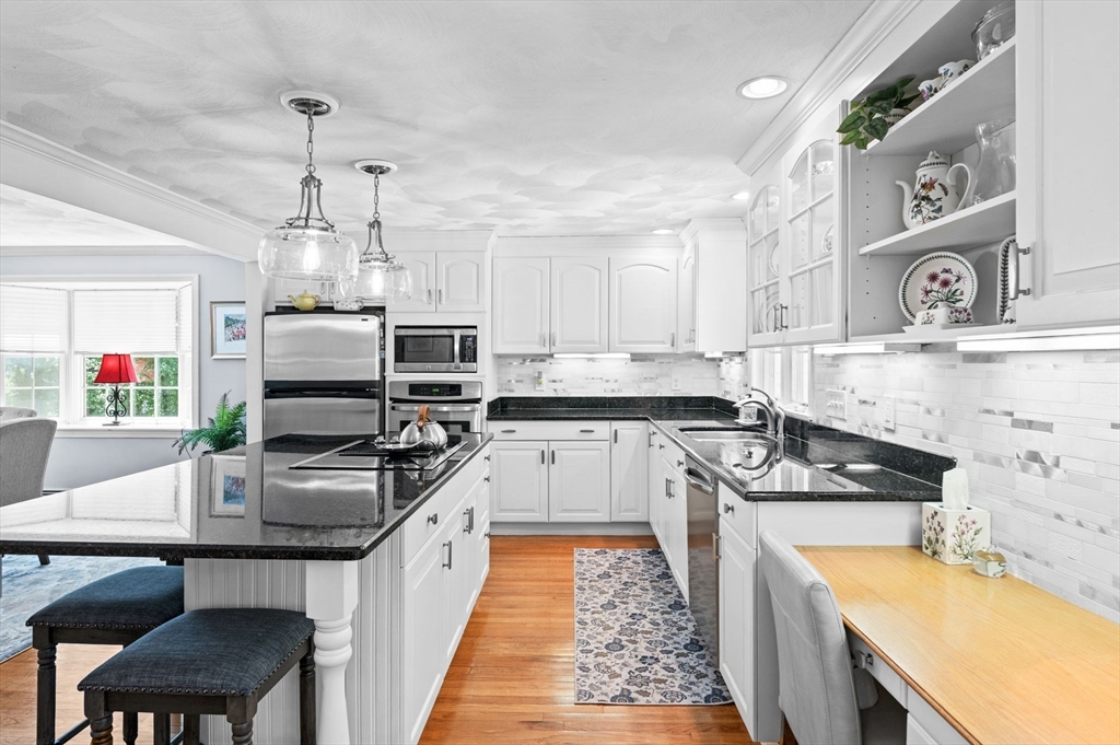 9 Sagamore Road Ipswich, MA 01938 - Photo 16 of 42 a kitchen with kitchen island granite countertop a sink appliances cabinets and counter space