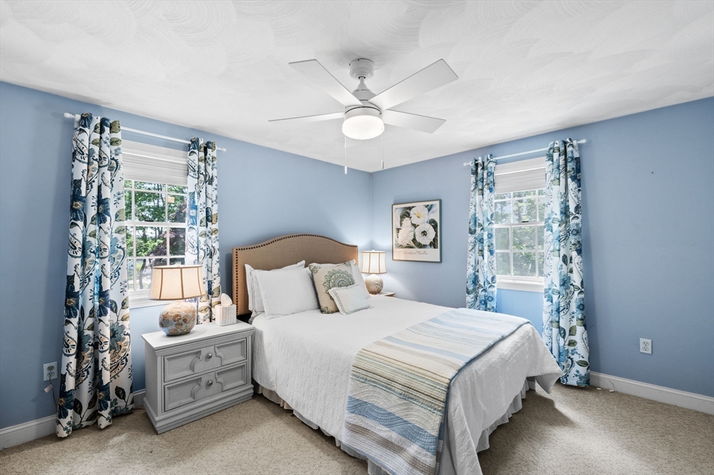 9 Sagamore Road Ipswich, MA 01938 - Photo 25 of 42 a bedroom with a bed and a chandelier