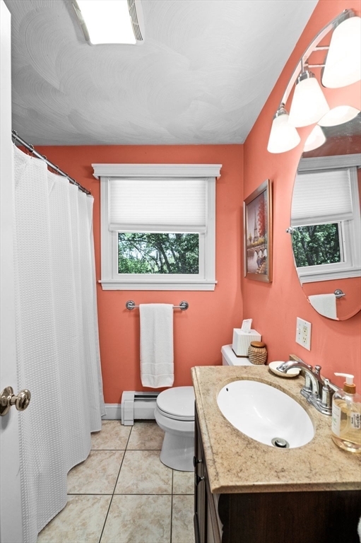 9 Sagamore Road Ipswich, MA 01938 - Photo 26 of 42 a bathroom with a sink a toilet and a mirror