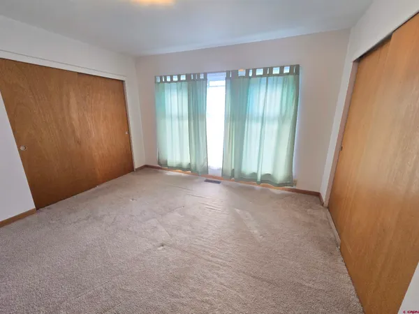 a view of an empty room with windows and yard