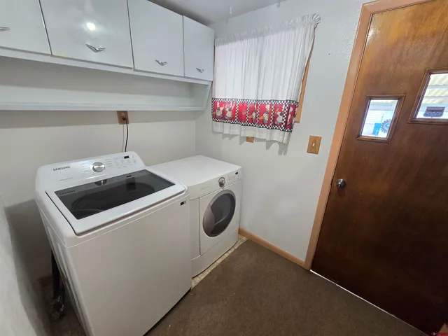 a view of a house with a small yard and a garage