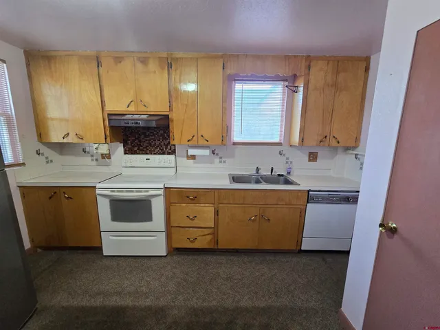 a view of a livingroom with a fireplace window and a ceiling fan