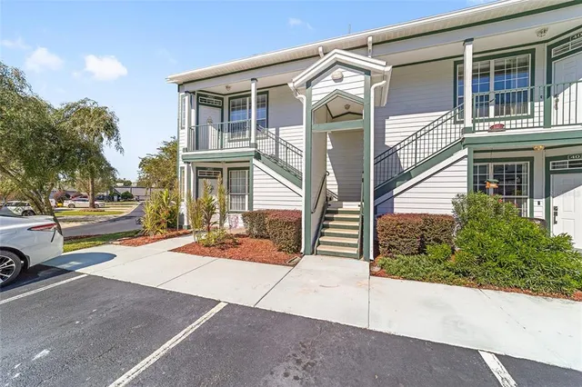 a view of a building with car parked