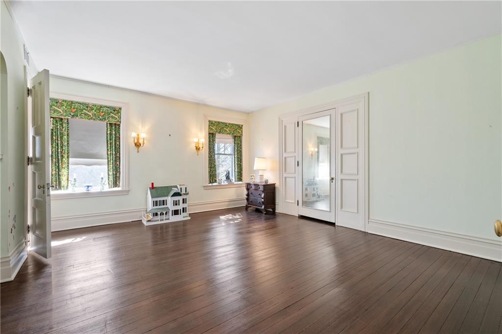 9 Little Sewickley Creek Road Sewickley, PA 15143 - Photo 26 of 34 an empty room with wooden floor and windows with curtains