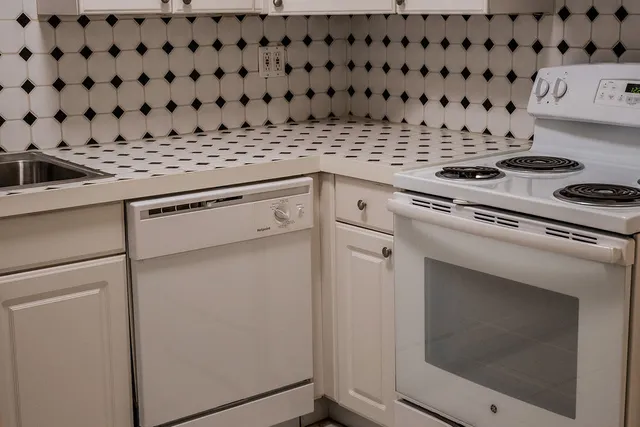 a stove top oven sitting inside of a kitchen