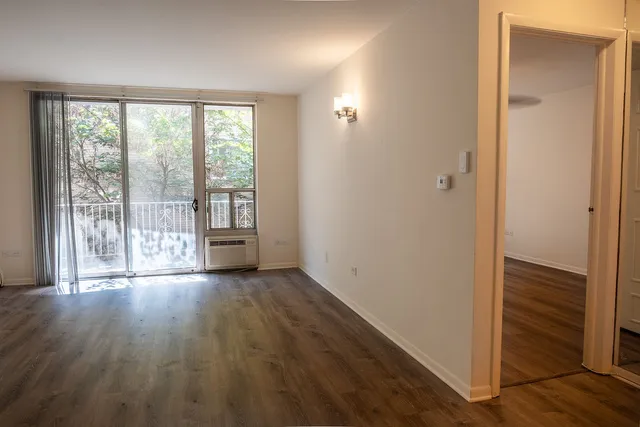 a view of an empty room and wooden floor