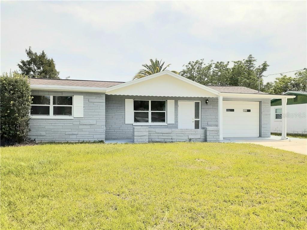 6412 Stone Road Port Richey, FL 34668 - Photo 1 of 1 a house that has a swimming pool in front of it