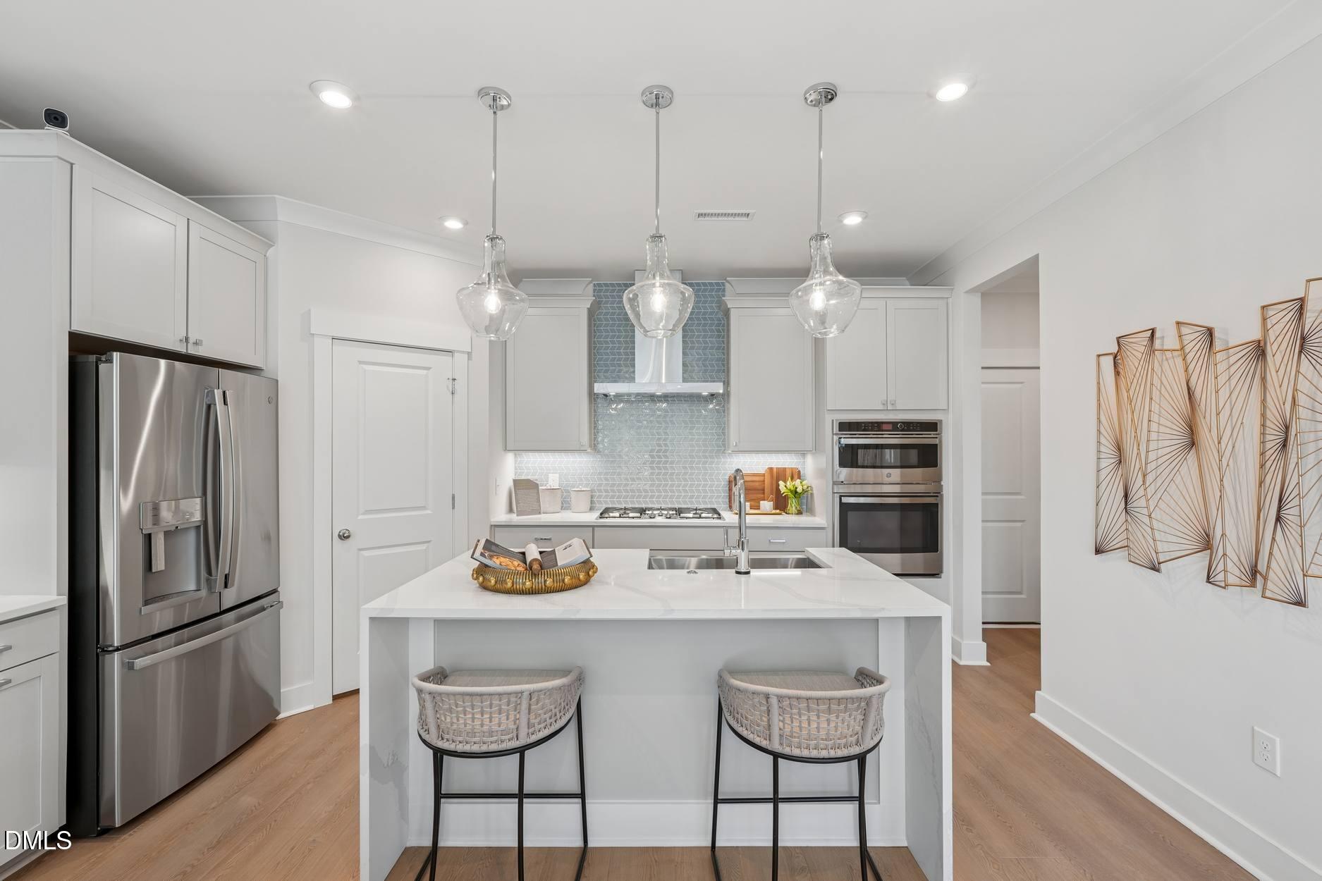 72 Wandering Way Pittsboro, NC 27312 - Photo 5 of 20 a kitchen with stainless steel appliances granite countertop a sink a stove a refrigerator cabinets and chairs
