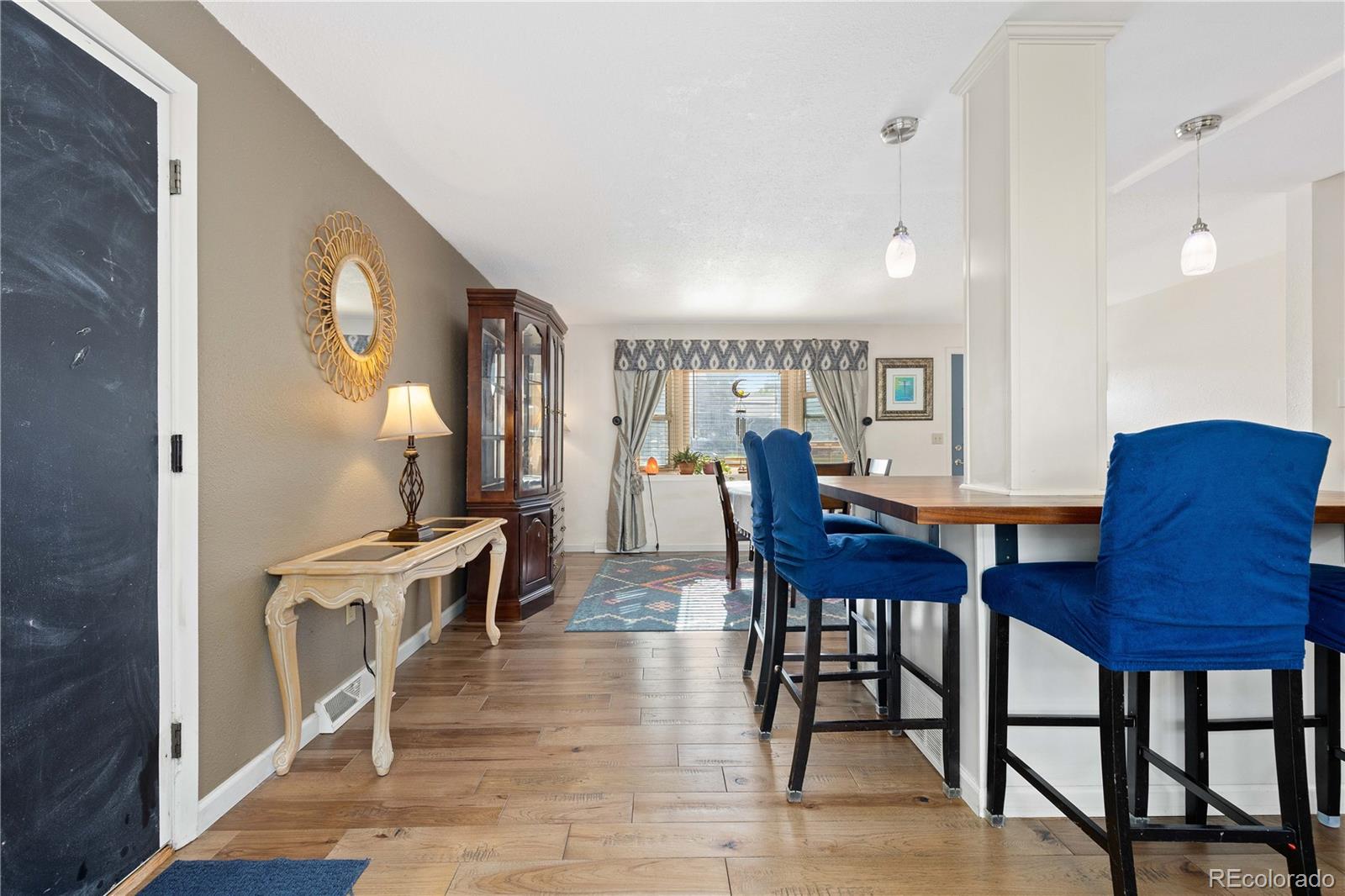 4374 East Peakview Circle Centennial, CO 80121 - Photo 14 of 45 a view of a a dining room with furniture window and wooden floor