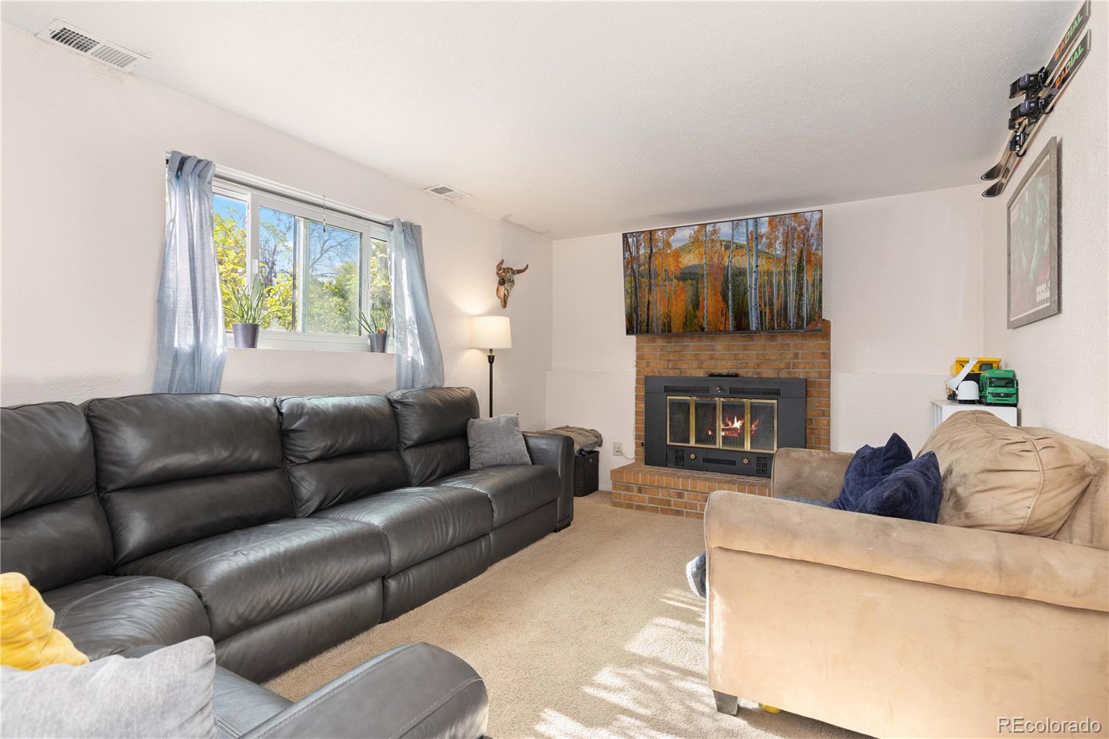 4374 East Peakview Circle Centennial, CO 80121 - Photo 19 of 45 a living room with furniture and a fireplace