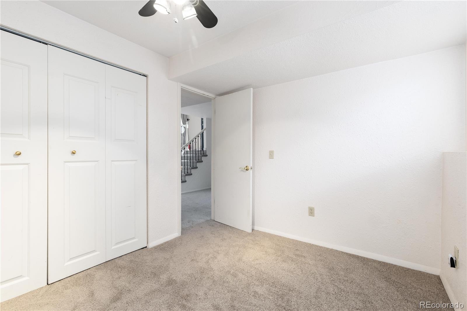 4374 East Peakview Circle Centennial, CO 80121 - Photo 29 of 45 an empty room with closet and windows