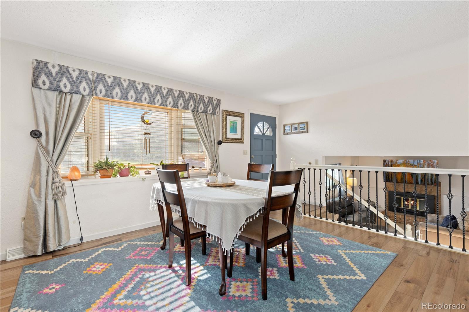 4374 East Peakview Circle Centennial, CO 80121 - Photo 8 of 45 a view of a dining room with furniture and wooden floor