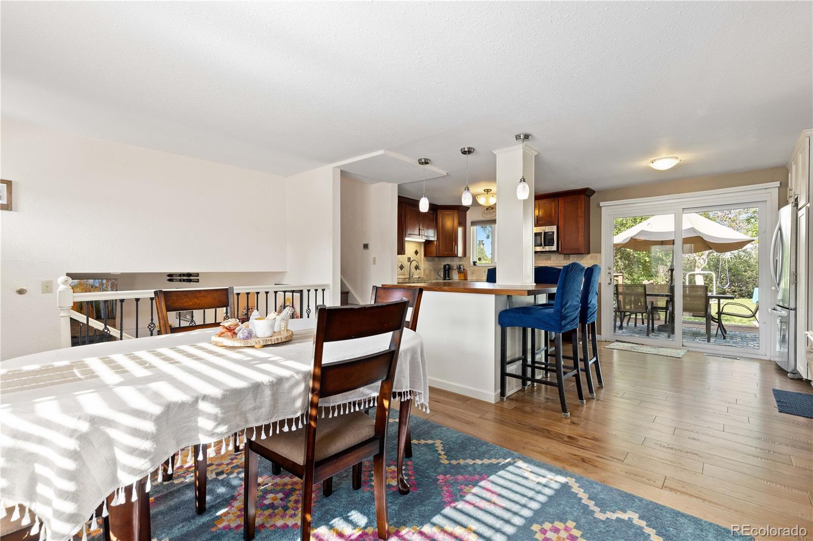 4374 East Peakview Circle Centennial, CO 80121 - Photo 9 of 45 a view of a dining room with furniture and wooden floor