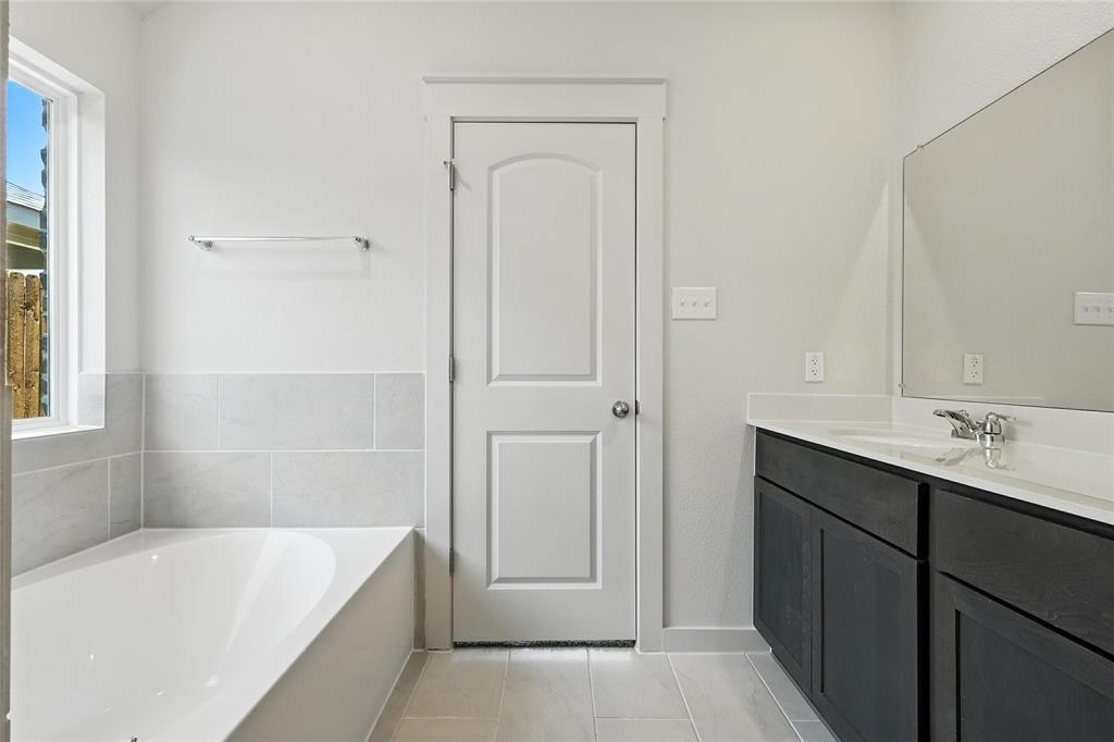 1795 Gleasondale Place Forney, TX 75126 - Photo 18 of 29 Full bathroom featuring vanity, a bath, and light tile patterned floors