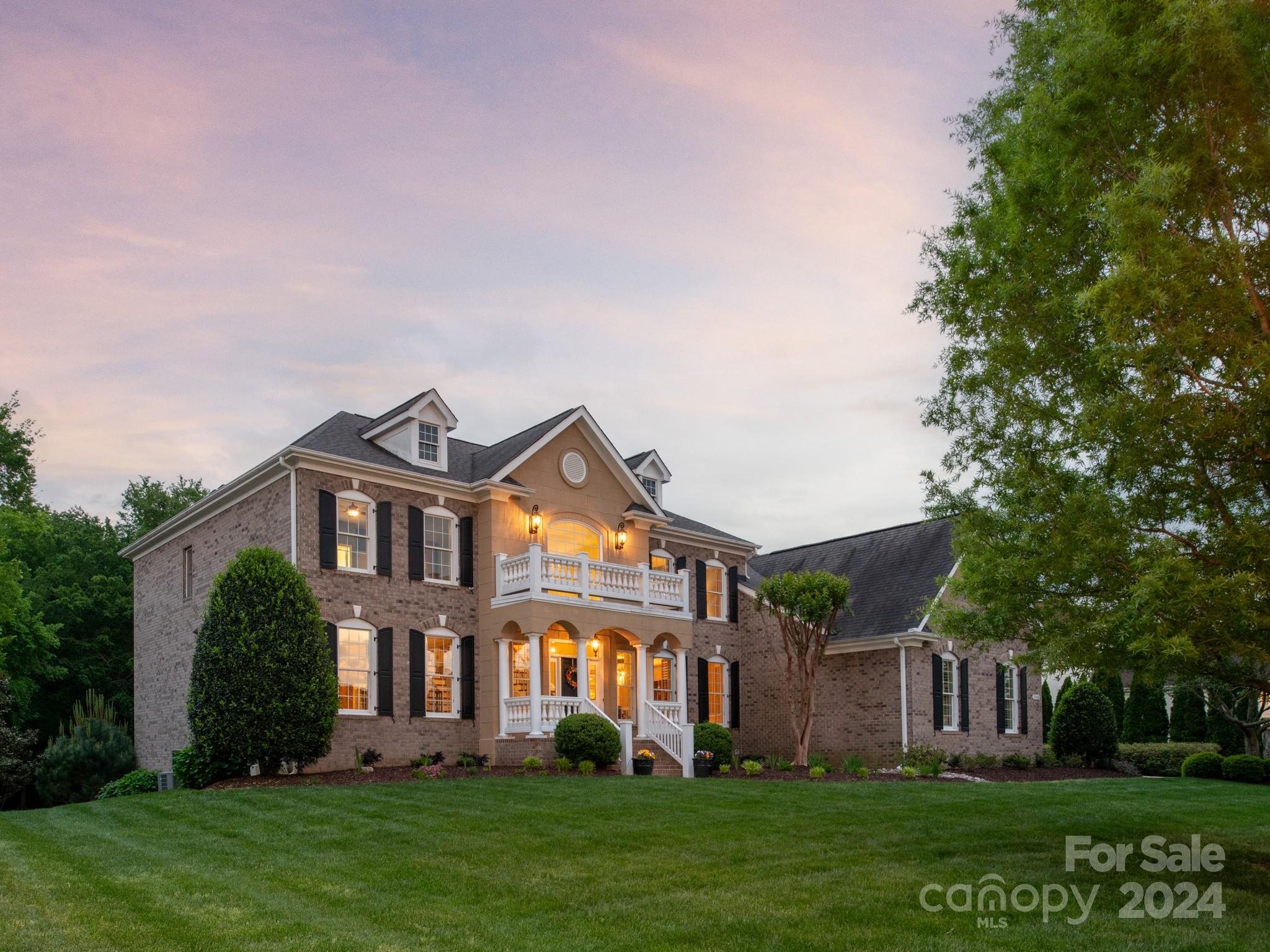 2008 Wheat Field Drive Marvin, NC 28173 - Photo 4 of 48 a front view of a house with a garden and trees