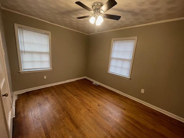 1185 Wright Road Memphis, TN 38122 - Photo 9 of 10 Unfurnished room with ornamental molding, dark wood-type flooring, and ceiling fan