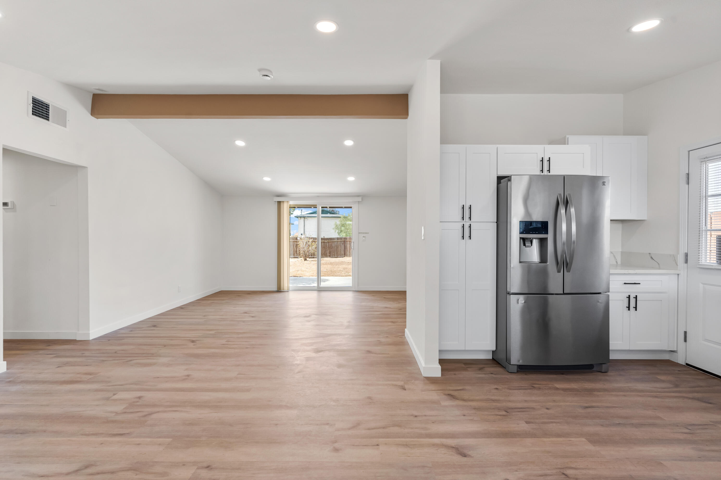 15593 M Street Mojave, CA 93501 - Photo 11 of 53 a view of a kitchen with a refrigerator and a stove top oven