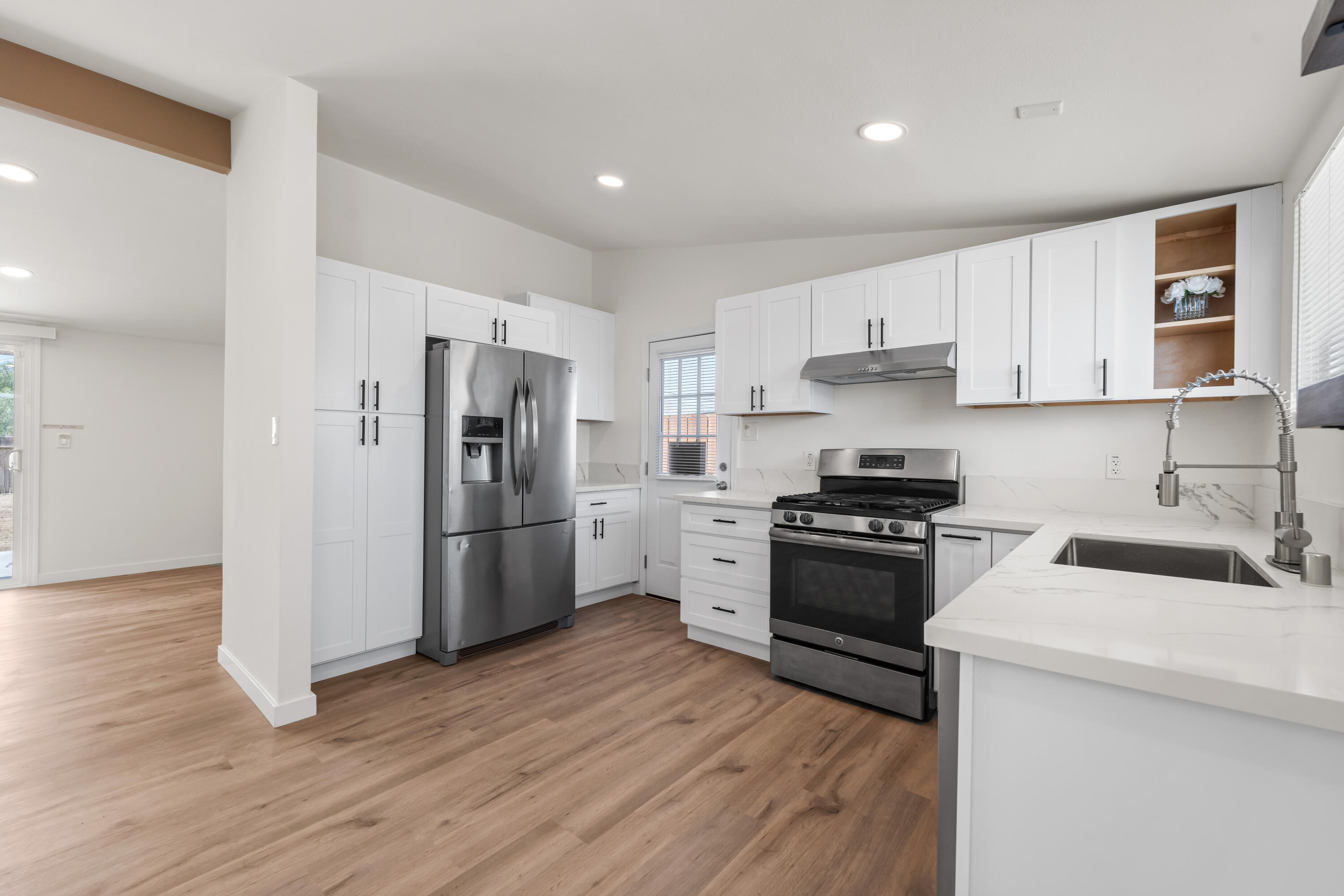 15593 M Street Mojave, CA 93501 - Photo 13 of 53 a kitchen with a refrigerator stove and wooden cabinets