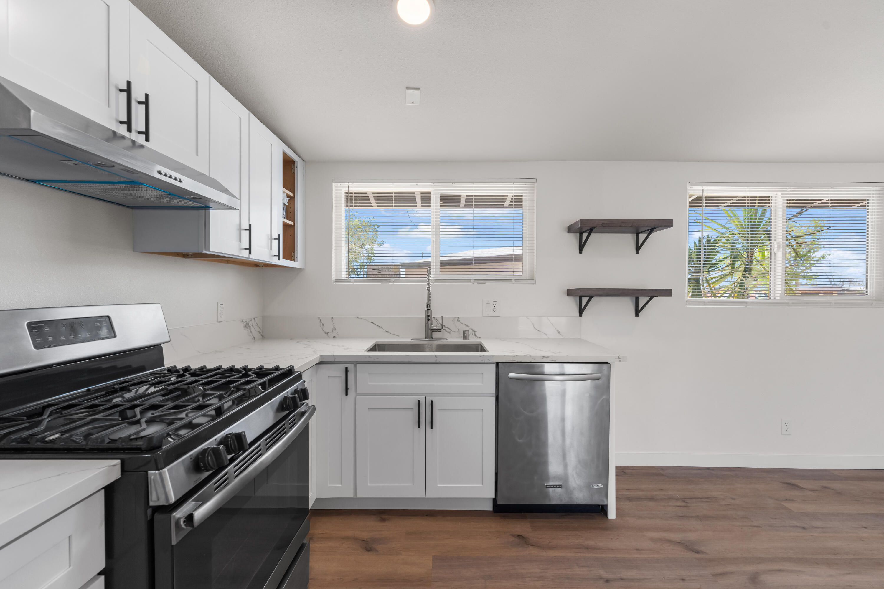 15593 M Street Mojave, CA 93501 - Photo 20 of 53 a kitchen with stainless steel appliances granite countertop a sink stove and cabinets