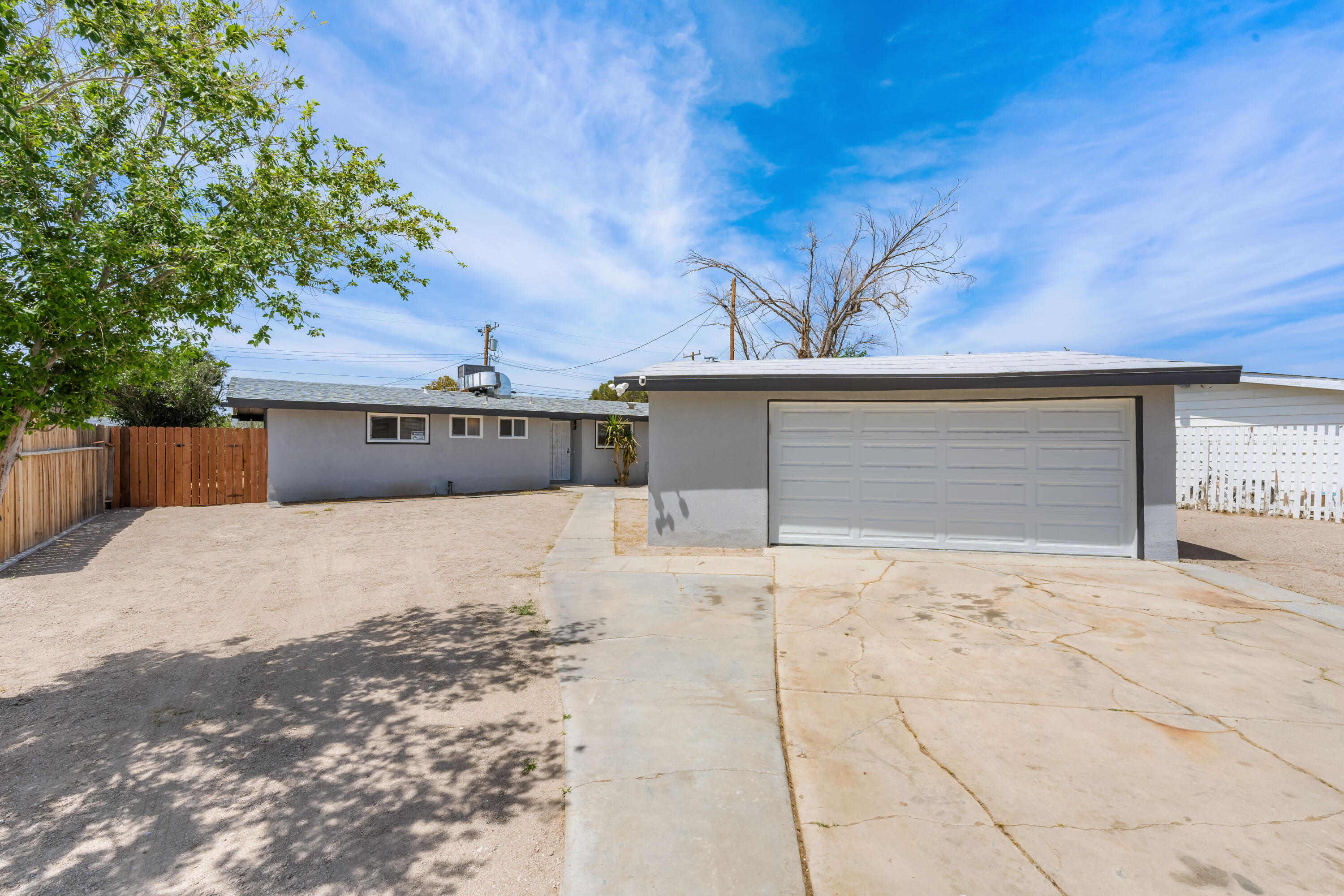 15593 M Street Mojave, CA 93501 - Photo 2 of 53 a front view of a house with a yard and garage