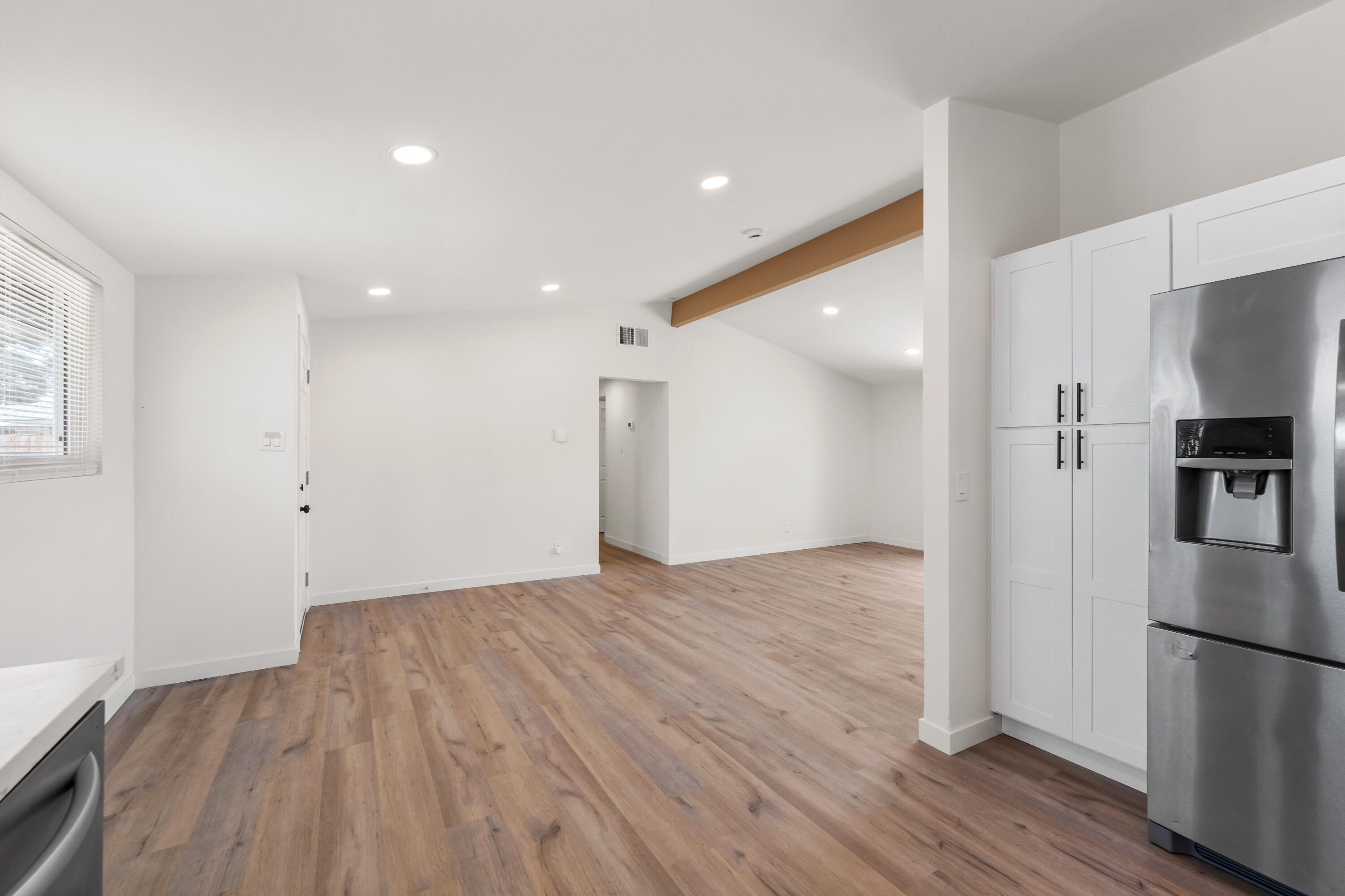 15593 M Street Mojave, CA 93501 - Photo 22 of 53 a view of a kitchen with a refrigerator and wooden floor