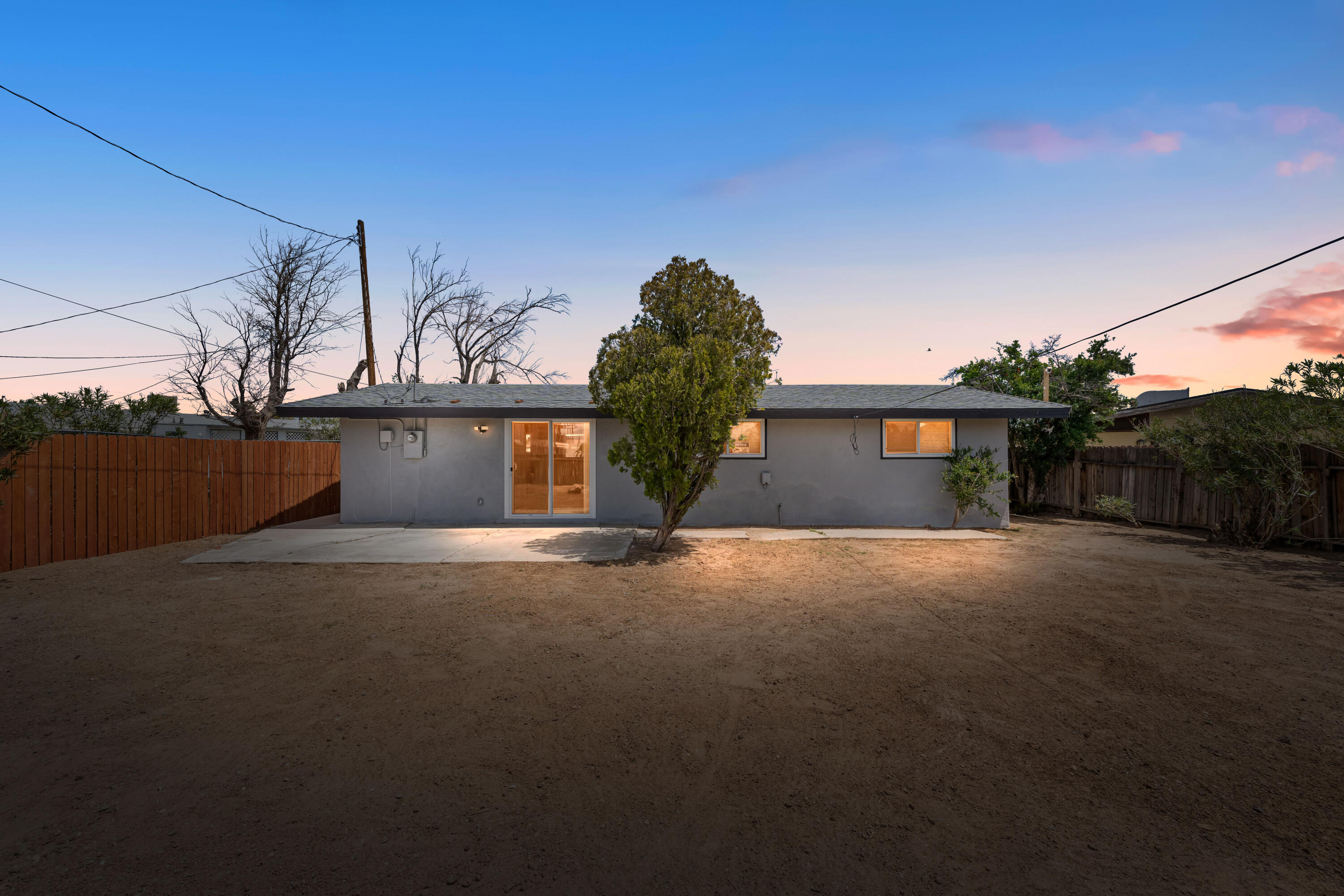 15593 M Street Mojave, CA 93501 - Photo 3 of 53 a front view of a house with a yard and garage