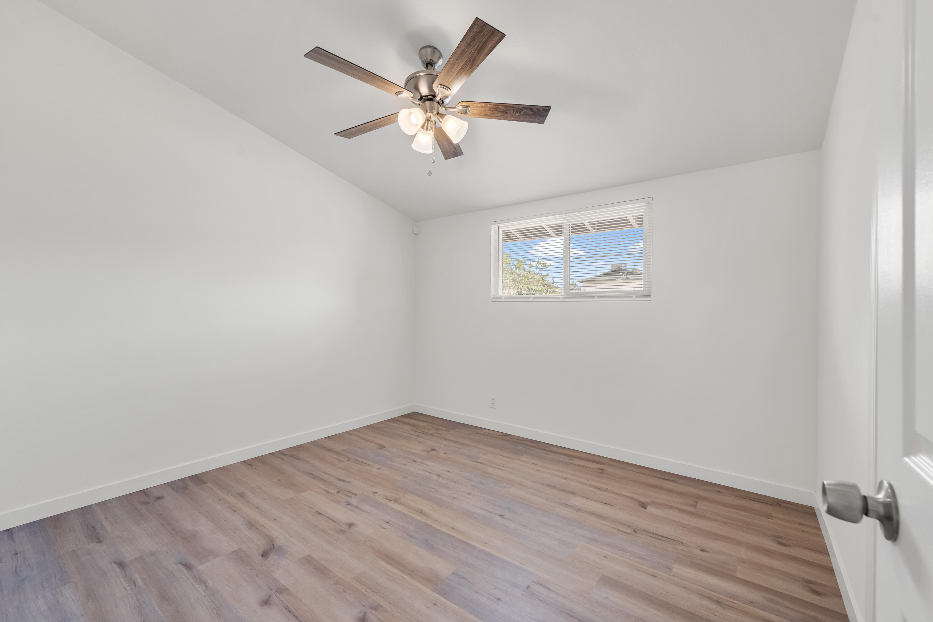 15593 M Street Mojave, CA 93501 - Photo 31 of 53 an empty room with wooden floor and windows