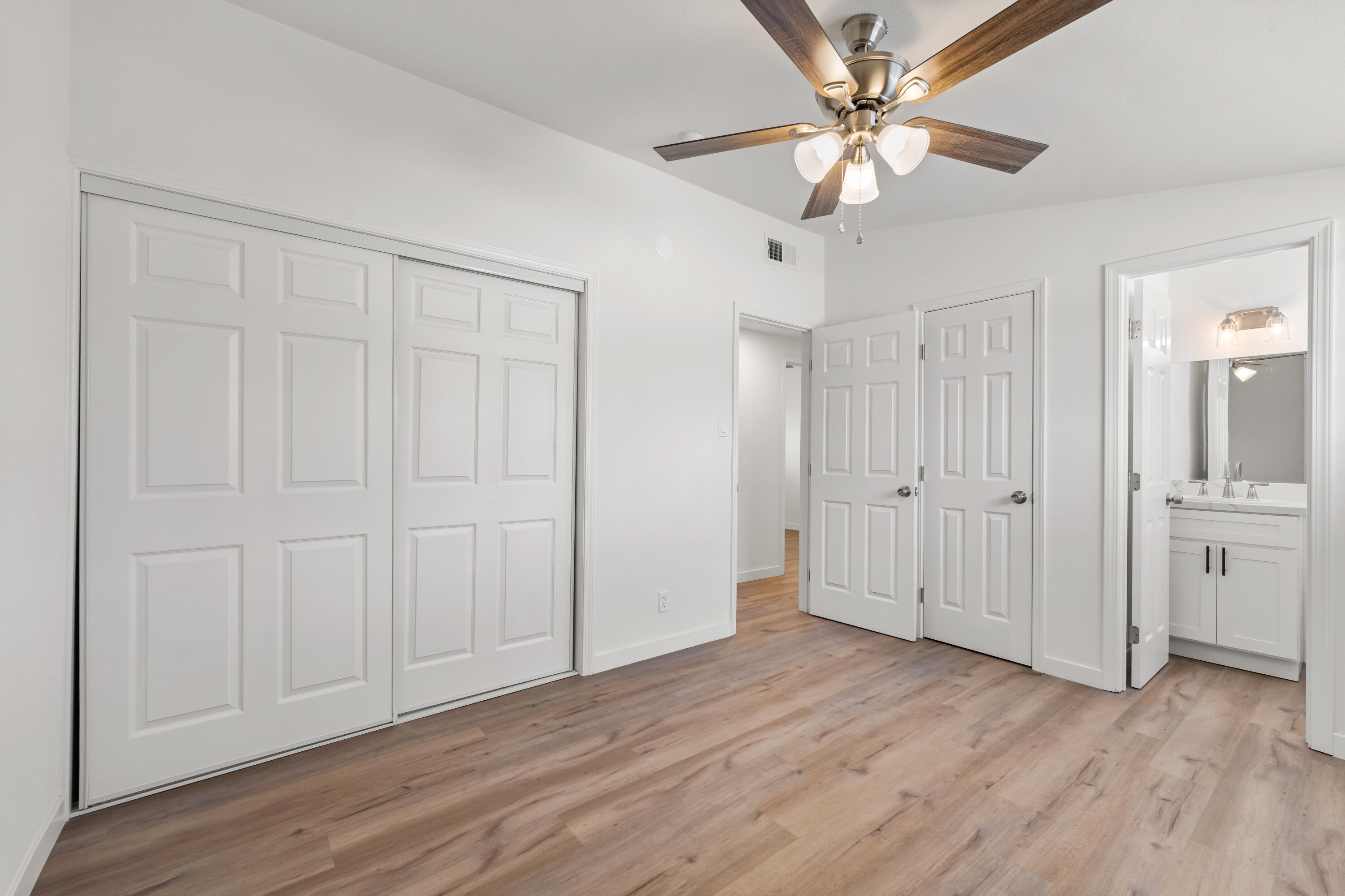 15593 M Street Mojave, CA 93501 - Photo 36 of 53 an empty room with wooden floor ceiling fan