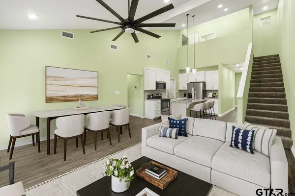 a living room with furniture and a wooden floor