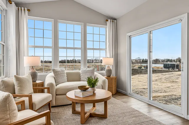 a living room with furniture and a floor to ceiling window