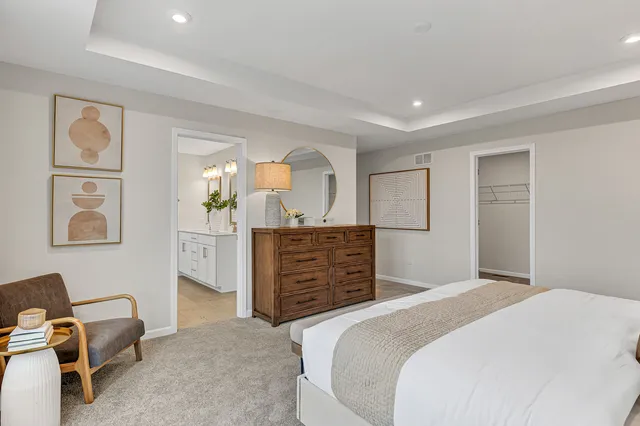 a bedroom with a bed and cabinets