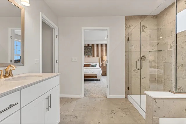 a en suite bathroom with a sink a mirror and a shower