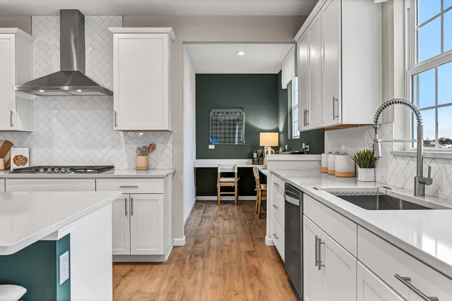 a kitchen with a sink cabinets and wooden floor