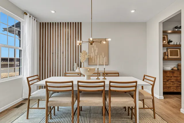 a dining room with furniture and window