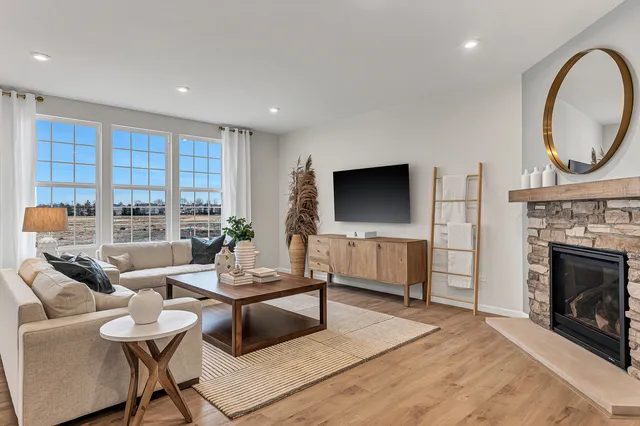 a living room with furniture a fireplace and a flat screen tv