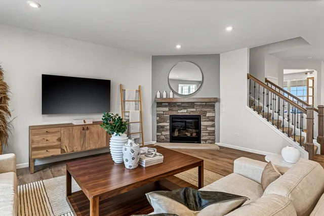 a living room with furniture a flat screen tv and a fireplace