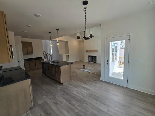 a large kitchen with kitchen island a counter space a sink stainless steel appliances and cabinets