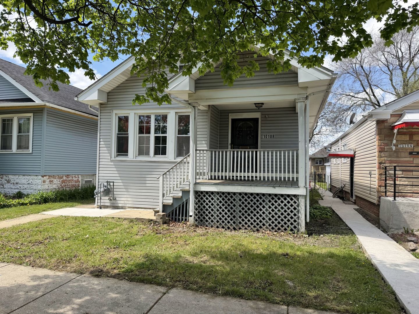 10108 South State Street Chicago, IL 60628 - Photo 1 of 20 a front view of a house with a yard