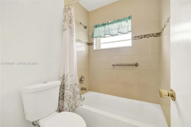 a bathroom with a toilet and a bathtub