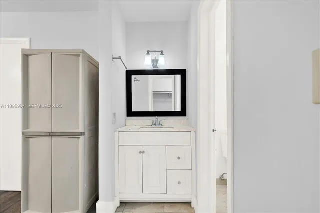 a room that has a mirror and a sink in it