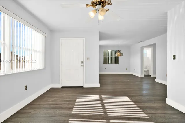 a view of a room with wooden floor and staircase