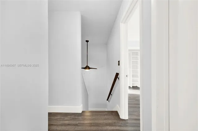 a view of a livingroom with wooden floor and staircase