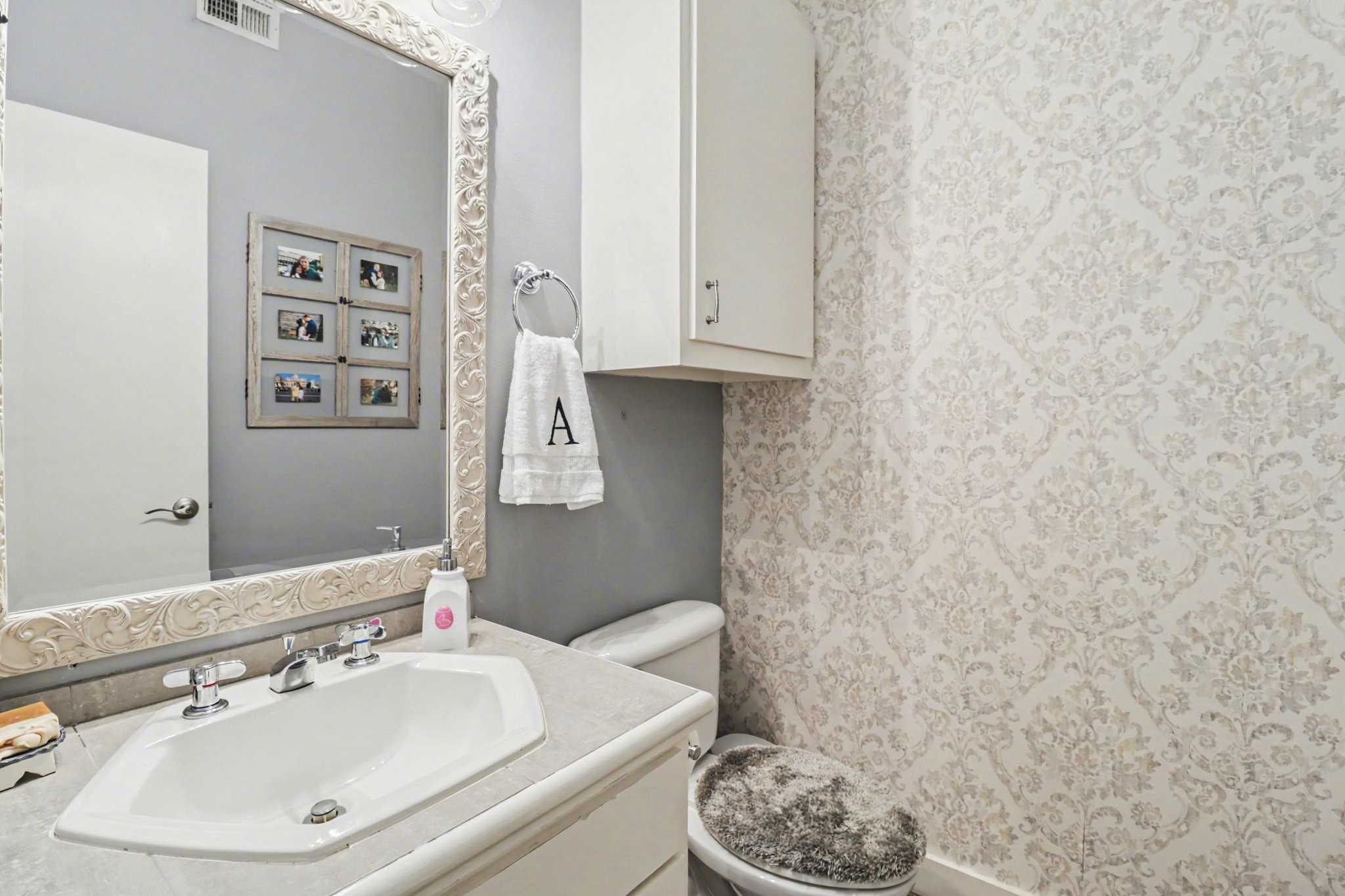 914 West 25th Street, Unit 2 Houston, TX 77008 - Photo 13 of 30 a bathroom with a sink a toilet and a mirror