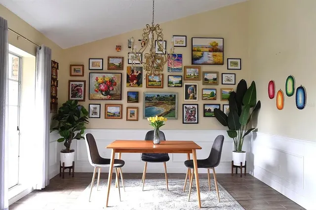 a view of a dining room with furniture and chandelier
