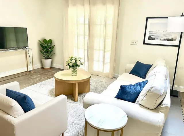 a living room with furniture and a flat screen tv