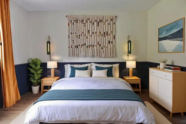 a bedroom with a bed and a potted plant