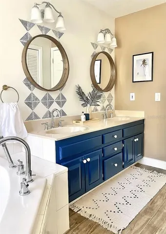 a bathroom with a double vanity sink and a mirror